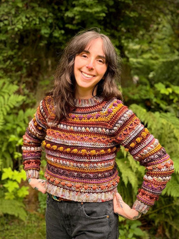 A crochet raglan sweater pattern featuring intricate stitch work, tapered sleeves, and colorwork. It contains many different stitches, making it fun to work up. It is an advanced level pattern in sizes XS-4X